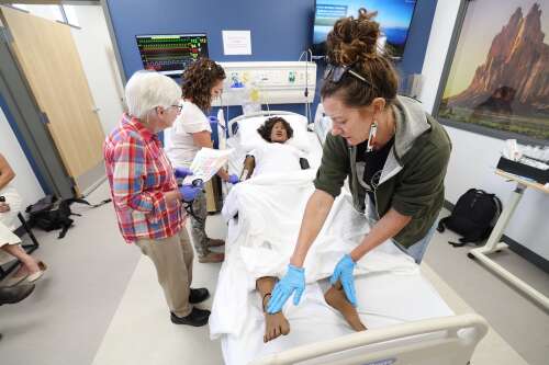 Southwest providers practice medicine on a manikin for the first rural health symposium at Fort Lewis College