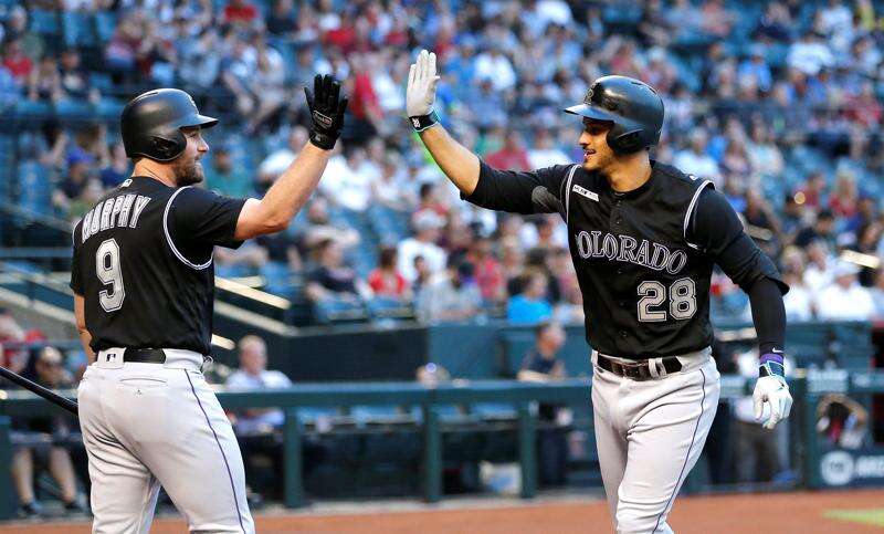 Colorado Rockies' Daniel Murphy celebrates as he scores after