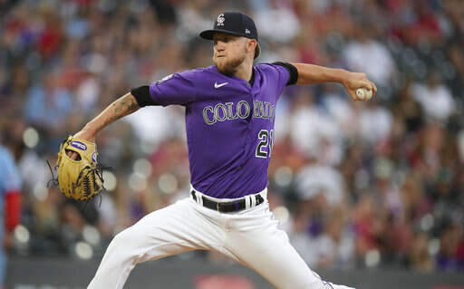 Colorado Rockies' Trevor Story looks skyward as he arrives home after  hitting a solo home run during the eighth inning of the team's baseball  game against the St. Louis Cardinals on Tuesday