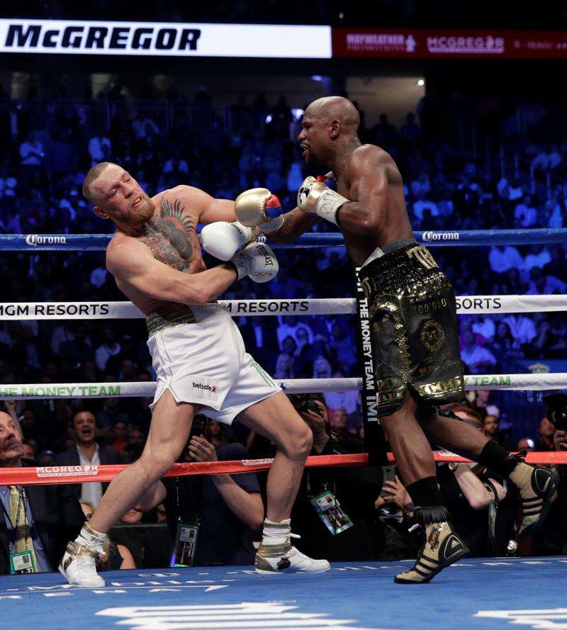 August 26, 2017 - Las Vegas, NEVADA, USA - Floyd Mayweather Jr., (Black and  Gold shorts), fights Conor McGregor (White Shorts)in a super welterweight  boxing match Saturday, Aug. 26, 2017, in Las