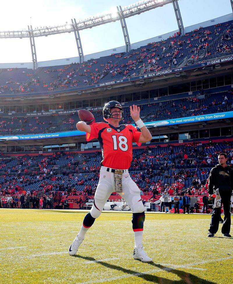 Denver Broncos quarterback Peyton Manning wears a glove on his throwing  hand warming up for game against the Baltimore Ravens in the AFC Divisional  Playoffs at Sports Authority Field at Mile High