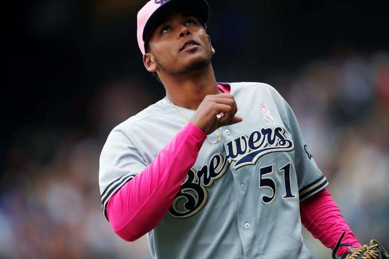 Milwaukee Brewers' Freddy Peralta walks to the dugout during the