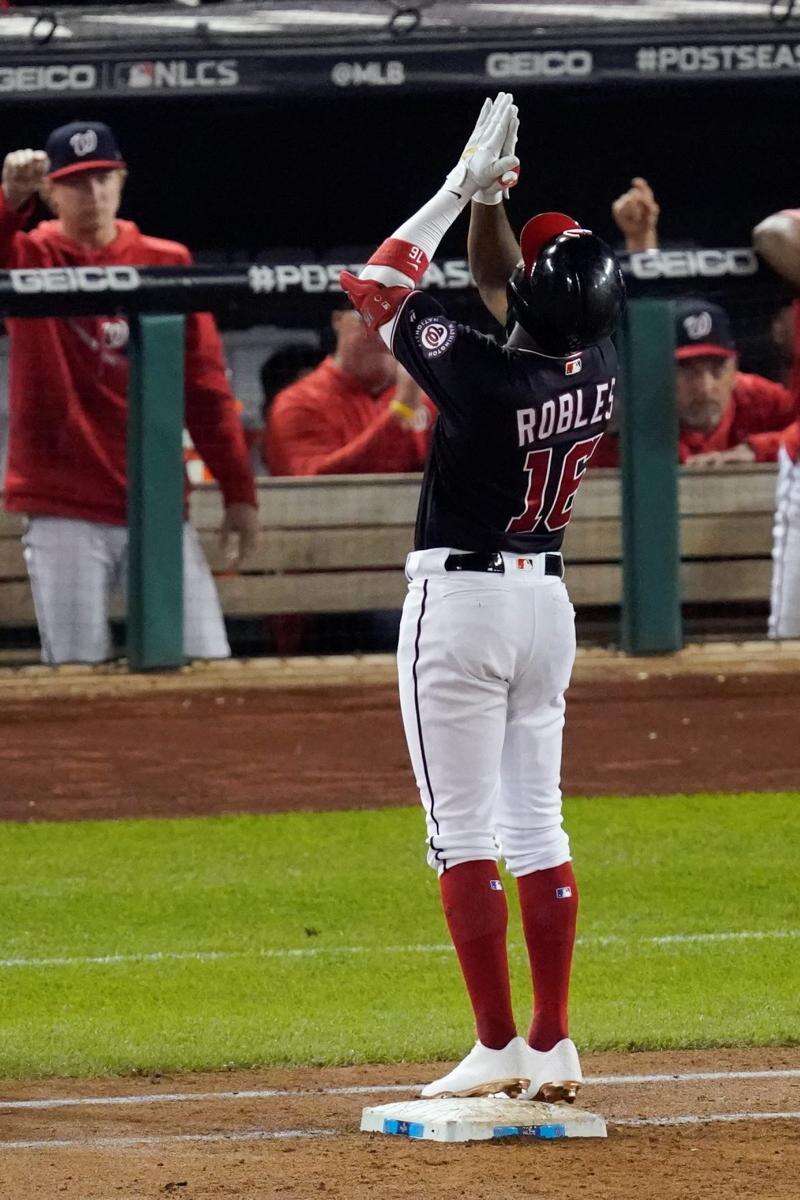 Washington Nationals' Anthony Rendon can't catch a ball hit by St