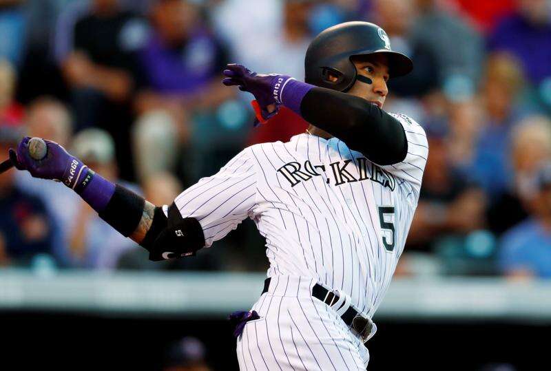 Complete with bushy beard and mullet, Blackmon leads Rockies