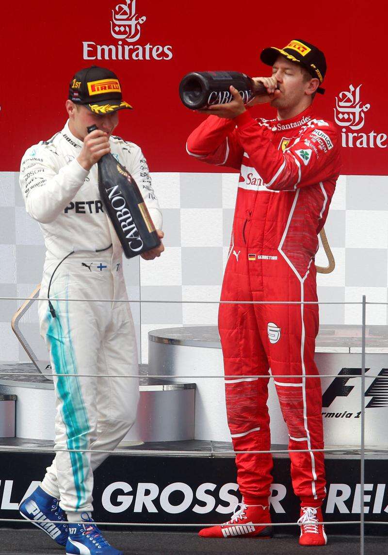 Red Bull driver Sebastian Vettel of Germany celebrates on his car