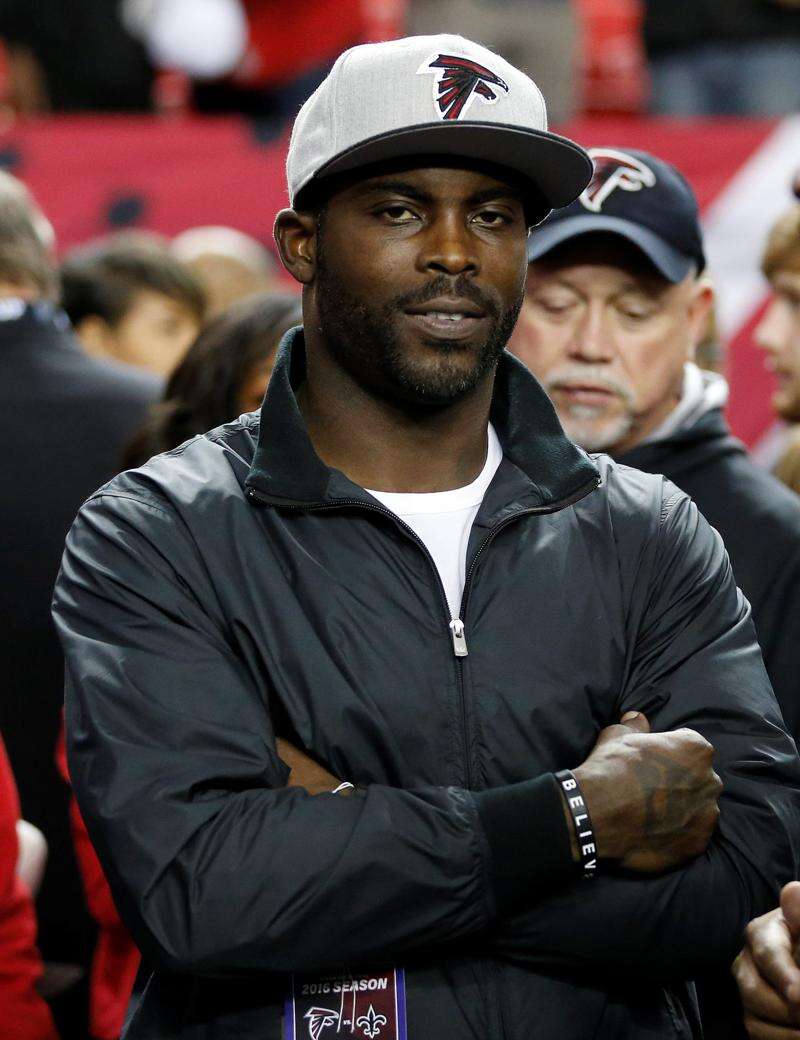 FILE** Atlanta Falcons quarterback Michael Vick stands on the