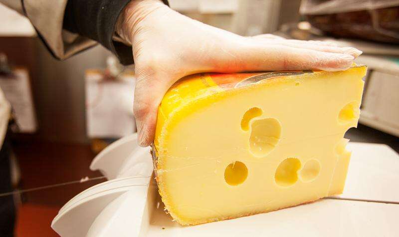 Why do some types of cheese have holes