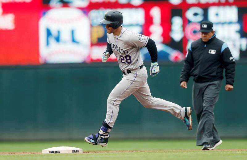 Colorado Rockies' Trevor Story looks skyward as he arrives home