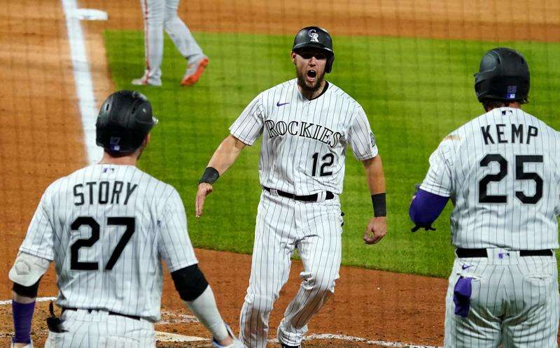 Colorado Rockies' Trevor Story looks skyward as he arrives home