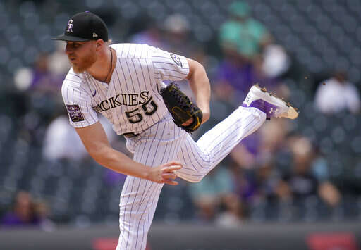 Raimel Tapia of the Colorado Rockies loses his helmet while