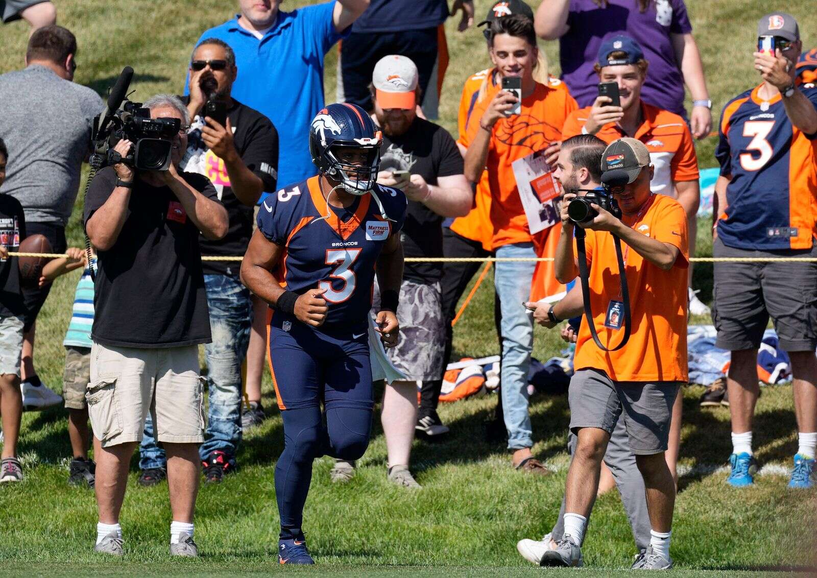 Peyton Manning and Russell Wilson take batting practice with the