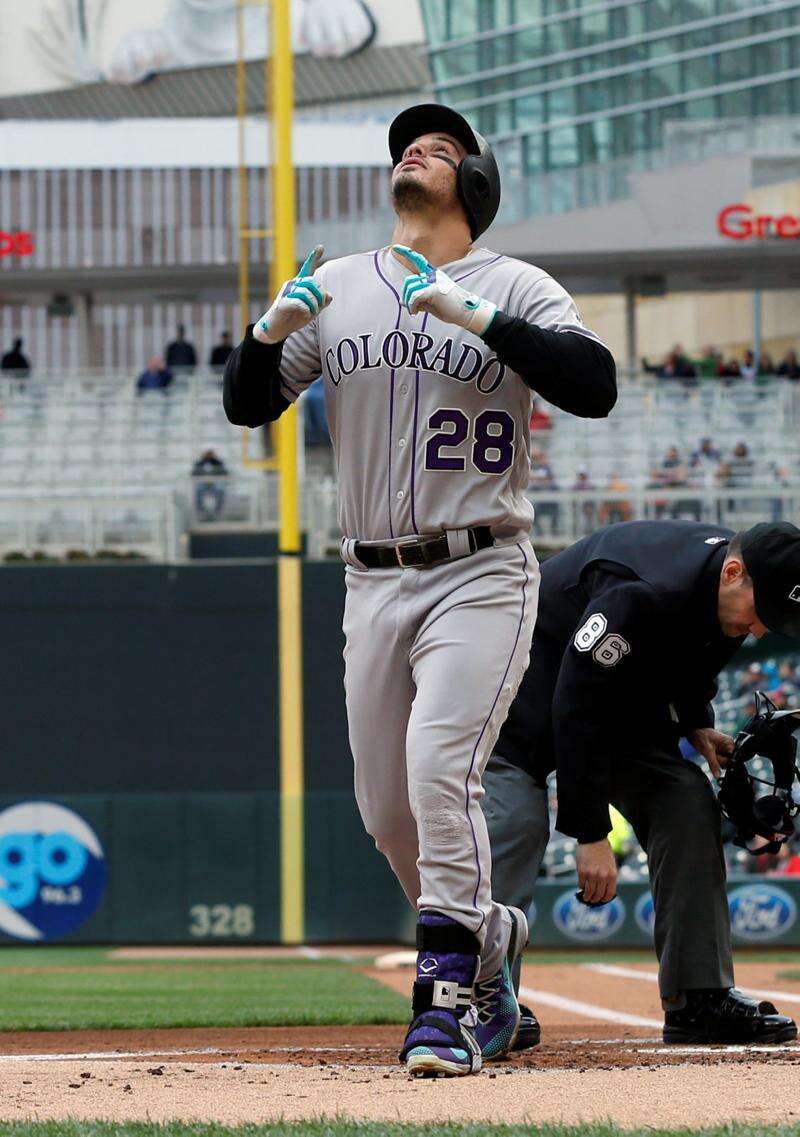 Colorado Rockies' Trevor Story looks skyward as he arrives home