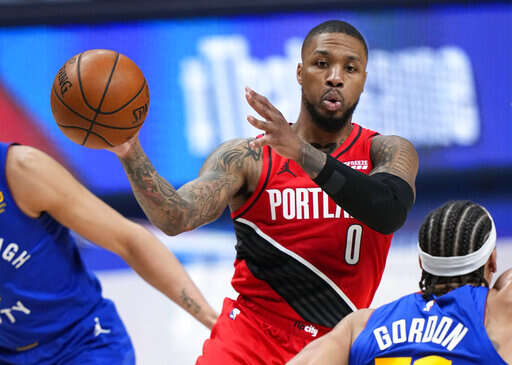 Portland Trail Blazers forward Carmelo Anthony (00) celebrates a three  point basket against the Denver Nuggets