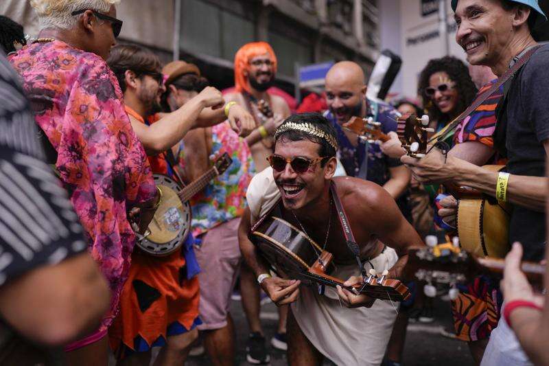 AP PHOTOS: A Carnival day in Brazil, from a morning street party to an  evening samba parade - The San Diego Union-Tribune