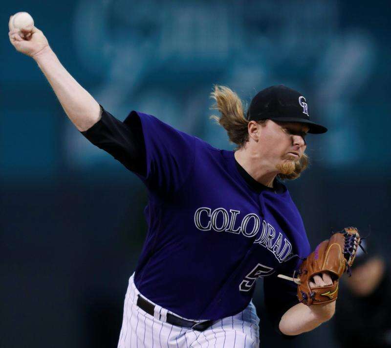 Colorado Rockies shortstop Charlie Culberson (23) makes the throw