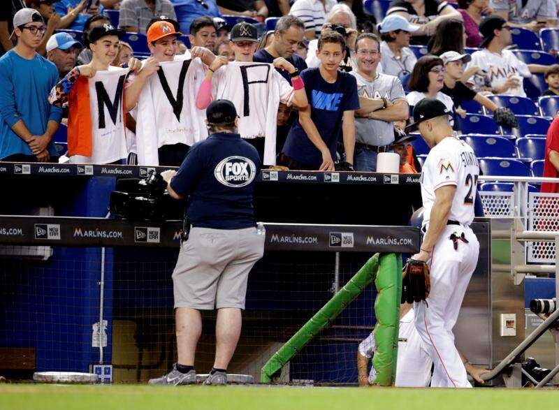 Miami Marlins' Giancarlo Stanton (27) rounds first after hitting a