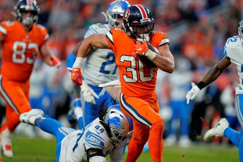 Denver Broncos running back Phillip Lindsay (30) shares a laugh with Las  Vegas Raiders running …