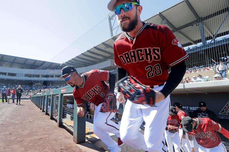 Will Clark looks out from a dugout before a baseball game between