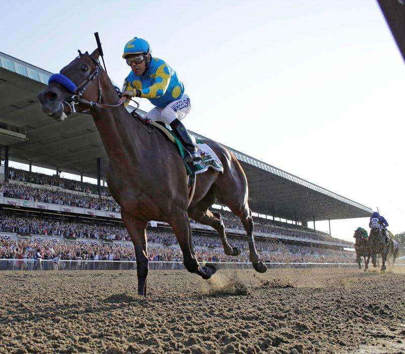 Triple Crown winning jockey Victor Espinoza waves to the crowd before  throwing out the ceremonial first pitch before the baseball game between  the Arizona Diamondbacks and San Diego Padres in a baseball