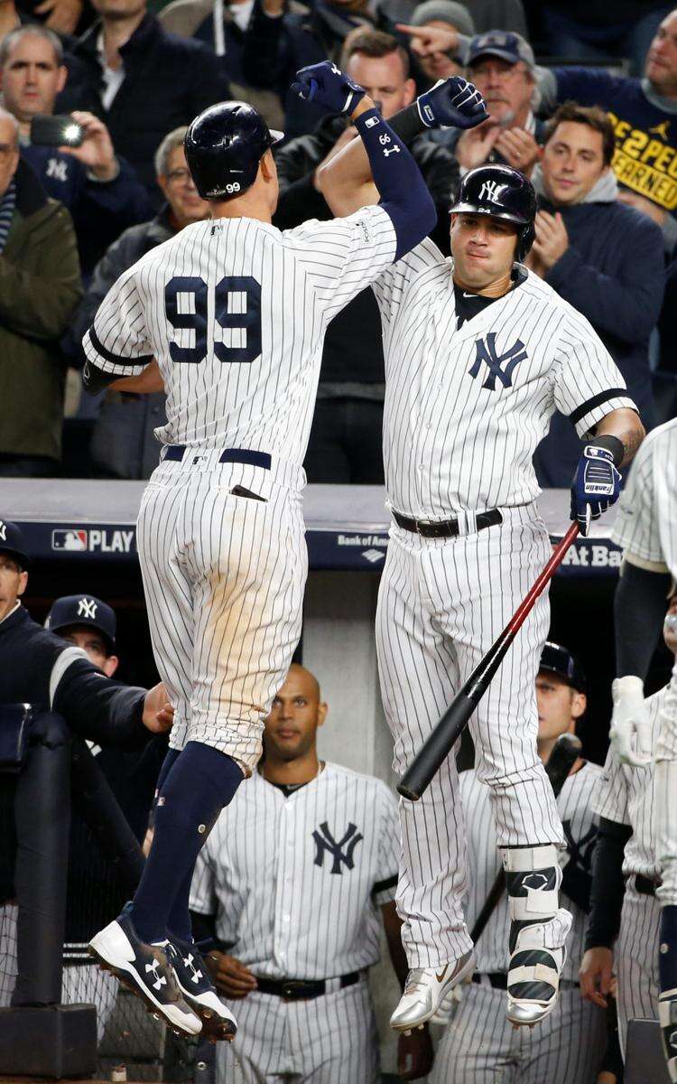 New York Yankees' Aaron Judge, left, celebrates with Gary Sanchez