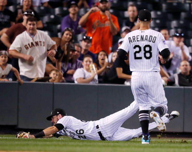 Carlos Gonzalez of the Colorado Rockies leads off second base