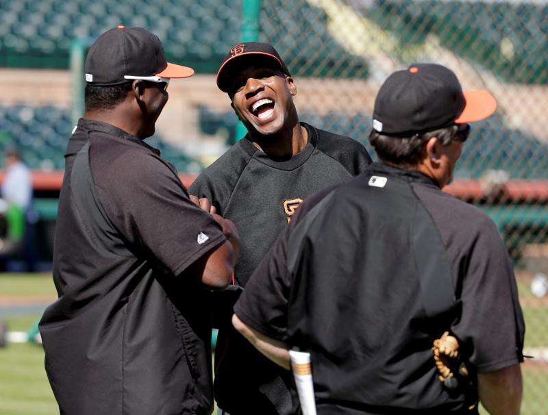 San Francisco Giants Barry Bonds removes his protective armor after he is  intentionally walked in the eighth inning by the Arizona Diamondbacks in  Phoenix, AZ April 17, 2006. Bonds was then lifted