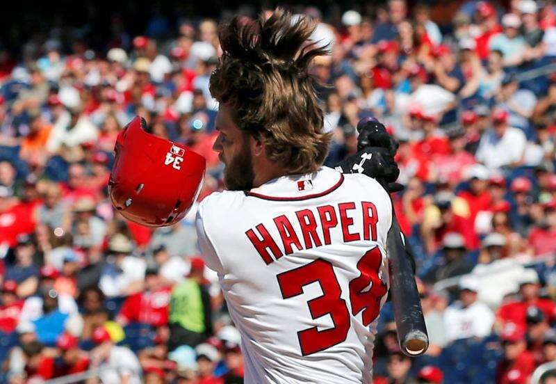 A Washington Nationals fan wears a Bryce Harper jersey before a