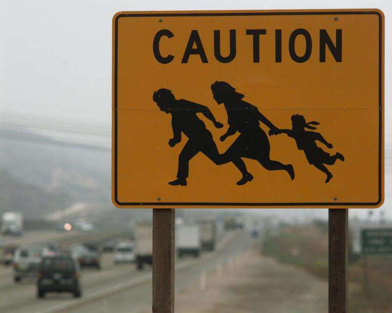 illegal immigrant crossing sign