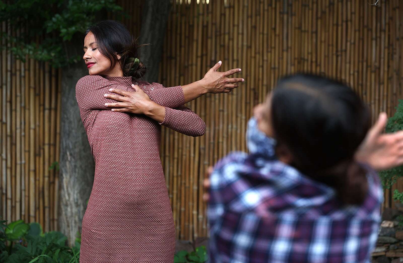 A girl is practicing yoga, she is wearing a dress 